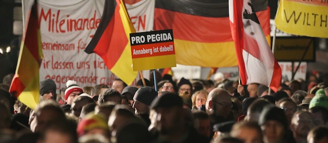 DRESDEN, GERMANY - DECEMBER 15: Supporters of the Pegida movement march with German flags at another of their weekly gatherings on December 15, 2014 in Dresden, Germany. Pegida is an acronym for 'Patriotische Europaeer Gegen die Islamisierung des Abendlandes,' which translates to 'Patriotic Europeans Against the Islamification of the West,' and has quickly gained a spreading mass appeal by demanding a more restrictive policy on Germany's acceptance of foreign refugees and asylum seekers. While Pegida disavows xenophobia in its public statements, critics charge that the movement is becoming a conduit for right-wing activists. The first Pegida march took place in Dresden in October and has since attracted thousands of participants to its weekly gatherings that have also begun spreading to other cities in Germany. Germany is accepting a record number of refugees this year, especially from war-torn Syria, and the country has also witnessed the rise of Salafist movements in numerous immigrant-heavy German cities. Both phenomena have promoted Pegida's rise and appeal. (Photo by Sean Gallup/Getty Images)