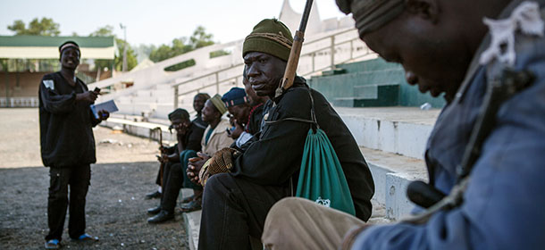 TO GO WITH AFP STORY BY BEN SIMON 
A band of hunters pose in Yola, state capital of Adamawa, on December 4, 2014 after taking part in an operation against Nigerian Islamist extremist group Boko Haram. Military and vigilantes forces acknowledge the crucial support of hunters in the fight against Boko Haram. AFP PHOTO / FLORIAN PLAUCHEUR (Photo credit should read FLORIAN PLAUCHEUR/AFP/Getty Images)