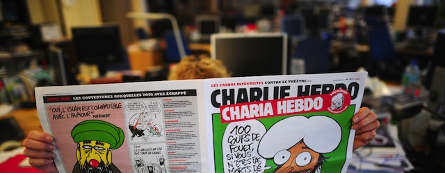 A person reads on November 1, 2011 in Paris an issue of Satirical French magazine Charlie Hebdo to be published on November 2, 2011, whose cover features prophet Mohammed. "In order fittingly to celebrate the Islamist Ennahda's win in Tunisia and the NTC (National Transitional Council) president's promise that sharia would be the main source of law in Libya, Charlie Hebdo asked Mohammed to be guest editor," said a statement.
AFP PHOTO MARTIN BUREAU (Photo credit should read MARTIN BUREAU/AFP/Getty Images)