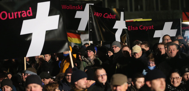 DRESDEN, GERMANY - JANUARY 12: Supporters of the Pegida gather with banners that show the names of mudered French satirical magazine Charlie Hebdo employees to demonstrate their solidarity with the victims of the recent Paris terror attacks during their weekly march on January 12, 2015 in Dresden, Germany. Pegida is an acronym for 'Patriotische Europaeer Gegen die Islamisierung des Abendlandes,' which translates to 'Patriotic Europeans Against the Islamification of the West,' and has quickly gained local mass appeal by demanding a more restrictive policy on Germany's acceptance of foreign refugees and asylum seekers. Critics, including leading German politicians, implored Pegida supporters not to march tonight and not to use the Paris attacks as a means to further their goals, which many view as xenophobic. The first Pegida march took place in Dresden in October and Pegida has since attracted thousands of participants to its weekly gatherings that have also begun spreading to other cities in Germany, though so far with only a few hundred participants. Germany is accepting a record number of refugees this year, especially from war-torn Syria, and the country has also witnessed the rise of Salafist movements in numerous immigrant-heavy German cities. Both phenomena have promoted Pegida's rise and appeal. (Photo by Sean Gallup/Getty Images)