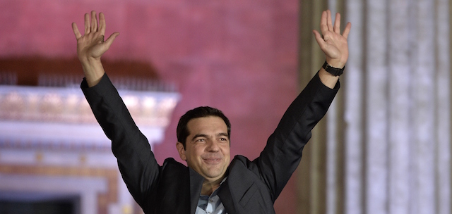 Syriza leader Alexis Tsipras greets supporters following victory in the election in Athens on January 25, 2015. Greek Prime Minister Antonis Samaras said the nation "had spoken" in handing victory to the anti-austerity Syriza party, and said he hoped the new government would not endanger the country's EU and euro membership. "I hand over a country that is part of the EU and the euro. For the good of this country, I hope the next government will maintain what has been achieved," Samaras said in a brief address to reporters. AFP PHOTO / LOUISA GOULIAMAKI (Photo credit should read LOUISA GOULIAMAKI/AFP/Getty Images)