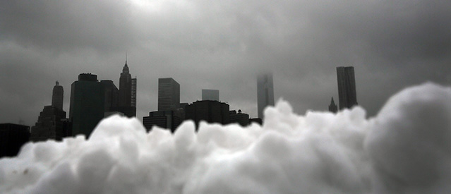 NEW YORK, NY - FEBRUARY 13: Part of the lower Manhattan skyline seen behind a pile of snow on February 13, 2014 in the Brooklyn borough of New York City. In what is turning out to be one of the snowiest winter's in recent memory for New York City and ouch of the East Coast, Thursday's weather is expected to bring a wintery mix of sleet and snow with total accumulation of 6 to 8 inches of snow before ending early Friday morning. (Photo by Spencer Platt/Getty Images)