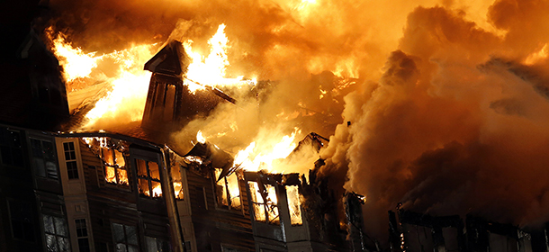 An apartment complex is engulfed by flames, Wednesday, Jan. 21, 2015, in Edgewater, N.J. Authorities had not determined the cause of the fire. (AP Photo/Julio Cortez)
