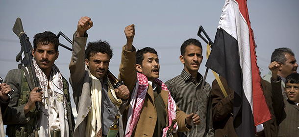 Houthi Shiite Yemenis raise their fists during clashes near the presidential palace in Sanaa, Yemen, Monday, Jan. 19, 2015. Rebel Shiite Houthis battled soldiers near Yemen's presidential palace and elsewhere across the capital Monday, despite a claim of a cease-fire being reached to halt the violence, witnesses and officials said. (AP Photo/Hani Mohammed)