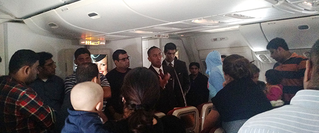 This photo provided by Rithvik Reddy shows passengers aboard Etihad Airways Flight EY 183 who where stuck on the tarmac for 12 hours. Hundreds of air travelers landed in San Francisco, Sunday, Jan. 4, 2015, safe but irritated after a 28-hour overseas flight they say included 12 hours on a tarmac in the Middle East without food or accurate flight information. (AP Photo/Rithvik Reddy)