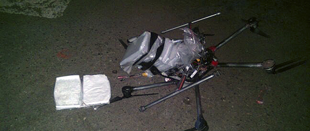In this image released by the Tijuana Municipal Police on Wednesday Jan. 21, 2015, a drone loaded with packages containing methamphetamine lies on the ground after it crashed into a supermarket parking lot in the city of Tijuana on Tuesday Jan. 20, 2015. According to police, six packets of the drug, weighing more than six pounds, were taped to the six-propeller remote-controlled aircraft. Authorities are investigating where the flight originated and who was controlling it. He said it was not the first time they had seen drones used for smuggling drugs across the border. Other innovative efforts have included catapults, ultralight aircraft and tunnels. (AP Photo/Secretaria de Seguridad Pública Municipal de Tijuana)