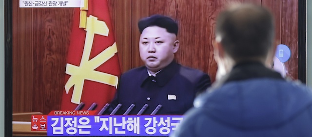 A man watches a TV news program showing North Korean leader Kim Jong-Un's New Year speech, at the Seoul Railway Station in Seoul, South Korea, Thursday, Jan. 1, 2015. Kim, in a nationally televised New Year's Day speech, says he is open to a summit with his South Korean counterpart. The letters read: " Kim Jong Un." (AP Photo/Ahn Young-joon)