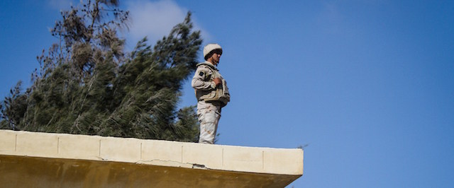 An Egyptian soldier stands guard along the Rafah border with Israel on July 19, 2014. Egyptian soldiers in north Sinai prevented an aid convoy of activists from reaching the Rafah border crossing with the embattled Palestinian Gaza Strip an AFP correspondent said. An army officer at the Balloza checkpoint, one of many along the desert highway to Rafah, told an AFP correspondent that the security situation in the restive peninsula was too unstable to allow the convoy of 11 buses and 500 activists to pass. AFP PHOTO / MOHAMED EL-SHAHED (Photo credit should read MOHAMED EL-SHAHED/AFP/Getty Images)