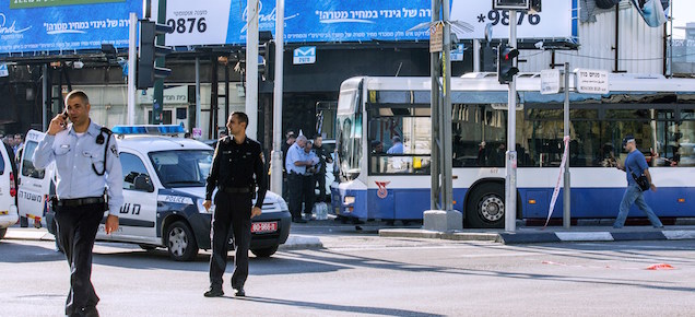 Israeli police officers stand at the scene of an attack after a Palestinian man stabbed at least five people on a Tel Aviv bus on January 21, 2015. The attacker struck in the morning rush hour in the heart of Israel's commercial capital before being shot by a passing prison officer, Israeli police said. AFP PHOTO / JACK GUEZ (Photo credit should read JACK GUEZ/AFP/Getty Images)