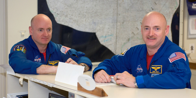 This undated photo provided by NASA, astronauts Mark Kelly, right, STS-124 commander, and Scott Kelly are pictured in the check-out facility at Ellington Field near NASA's Johnson Space Center in Houston. NASA announced Friday, March 7, 2014, that Mark Kelly and astronaut Scott Kelly will participate in 10 different investigations. Craig Kundrot, deputy chief scientist of NASA's Human Research Program, says in a news release that the brothers provide a unique opportunity to study two people with the same genetics who were in different environments. Officials say Scott Kelly spent a year in space while Mark Kelly was on Earth. NASA says it is hoping the studies can be the basis for future research initiatives. (AP Photo/NASA)