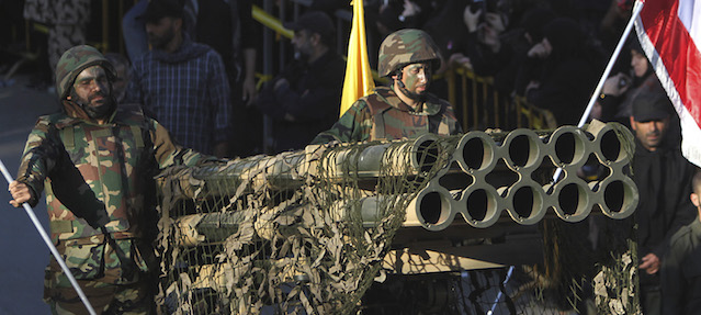 Hezbollah fighters stand on their armed vehicle with multiple rocket launchers, as they parade during a rally to mark the 13th day of Ashoura, in the southern market town of Nabatiyeh, Lebanon, Friday, Nov. 7, 2014. Shiites mark Ashoura, the tenth day of the Islamic month of Muharam, to commemorate the Battle of Karbala in the 7th century when Imam Hussein, a grandson of Prophet Muhammad, was killed in present-day Iraq. (AP Photo/Mohammed Zaatari)