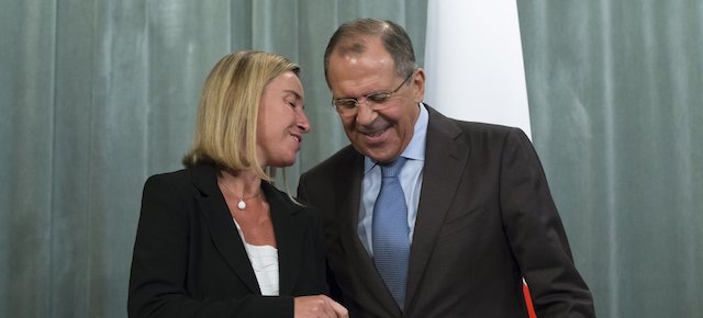 Russian Foreign Minister Sergey Lavrov, right, speaks to Italian Foreign Minister Federica Mogherini as they leave after a news conference following their talks in Moscow, Russia, Wednesday July 9, 2014. (AP Photo/Alexander Zemlianichenko)