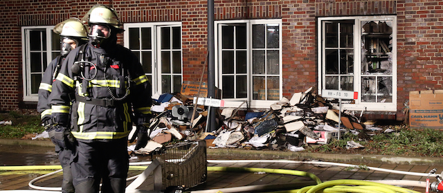 Firefighters stand outside the building of the 'Hamburger Morgenpost' in Hamburg, northern Germany, Sunday morning, Jan. 11, 2015. According to police fire broke out in an archive room of the paper after an arson attack. The newspaper ran caricatures of the Charlie Hebdo newspaper after the attack on Wednesday. (AP Photo/dpa, Bodo Marks)