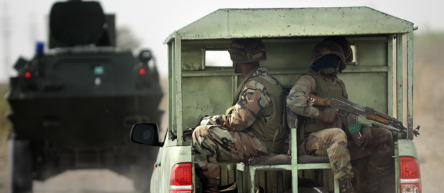 Nigerian soldiers patrol in the north of Borno state close to a Islamist extremist group Boko Haram former camp on June 5, 2013 near Maiduguri. Nigeria's military yesterday disclosed details of its offensive against Islamist militants, describing a series of events that saw insurgents take control of a remote area before being pushed out by soldiers. AFP PHOTO / Quentin Leboucher (Photo credit should read Quentin Leboucher/AFP/Getty Images)