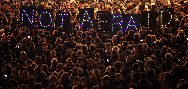 People gather in solidarity of the victims of a terror attack against a satirical newspaper, in Paris, Wednesday, Jan. 7, 2015. Masked gunmen shouting "Allahu akbar!" stormed the Paris offices of a satirical newspaper Wednesday, killing 12 people, including the paper's editor, before escaping in a getaway car. It was France's deadliest terror attack in living memory. (AP Photo/Thibault Camus)