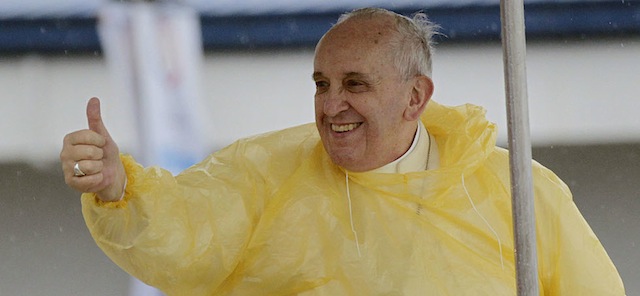 Wearing a yellow raincoat, Pope Francis gives a thumbs up to the faithful as he arrives in Tacloban, Philippines, Saturday, Jan. 17, 2015. A rain-drenched but lively crowd wearing yellow and white raincoats welcomed Pope Francis in the typhoon-ravage central Philippine city of Tacloban early Saturday, chanting "Papa Francesco, Viva il Papa!" (AP Photo/Wally Santana)