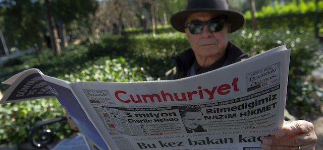 A man reads Cumhuriyet, the leading pro-secular Turkish newspaper, in Istanbul, Turkey, Wednesday, Jan. 14, 2015. Cumhuriyet said police stopped trucks as they left its printing center to check the paper's content after it decided to print a selection of Charlie Hebdo caricatures. Cumhuriyet said police allowed distribution of the newspaper to proceed on Wednesday after verifying that the satirical French newspaper's controversial cover featuring the Prophet Muhammad was not published.(AP Photo)