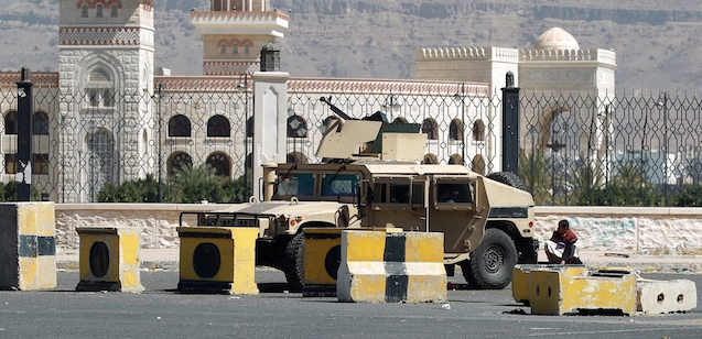 A Shiite Huthi militiaman sits near a tank confiscated from the army in the area around the presidential palace in the capital Sanaa, on January 22, 2015. Shiite militiamen maintained a tight grip on Yemen's capital today with fighters deployed around the presidential palace despite a deal to end what authorities termed a coup attempt. President Abdrabuh Mansur Hadi's abducted chief of staff remained in the hands of the Huthi militia, which seized control of most of Sanaa in September after sweeping south from its stronghold in the northern highlands. AFP PHOTO / MOHAMMED HUWAIS (Photo credit should read MOHAMMED HUWAIS/AFP/Getty Images)