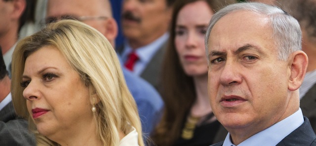 Israeli Prime Minister Benjamin Netanyhau (R) and his wife Sara attend a ceremony to bury the ashes of British WW1 veteran hero Lt. Col. John Henry Patterson and his wife Frances Helena on December 4, 2014 in the Israeli military cemetery of Avihayil in Netanya, north of Tel Aviv. Patterson, who was a Protestant, gained iconic status as the first commander to lead Jewish forces onto the field of battle during the Great War - playing a critical part in the history of Zionism. Patterson's final wishes was that both he and his wife eventually be interred in Israel, ideally, with or close to the men he commanded during World War I. AFP PHOTO / JACK GUEZ (Photo credit should read JACK GUEZ/AFP/Getty Images)