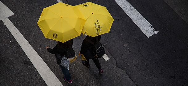 HONG KONG - FEBRUARY 01: Pro-democracy protesters hold yellow umbrellas during a march for democracy on February 1, 2015 in Hong Kong, Hong Kong. Thousands of pro-democracy supporters gathered in Hong Kong for the first major rally since the occupy movement took over parts of Hong Kong, a stand off that lasted over 2 months. Protestors are calling for autonomy in Hong Kong chief executive elections as China continues to have control over who can run for the position. (Photo by Lam Yik Fei/Getty Images)