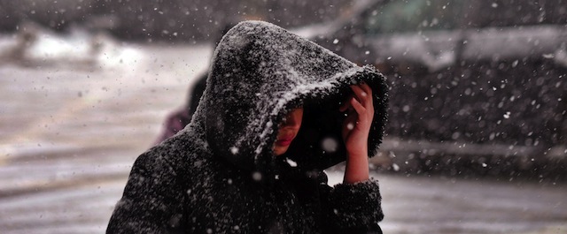 A woman walks on a street during a snow storm in New York on February 2, 2015. More than 3,000 flights were cancelled on February 2, as a fresh winter storm dumped snow, sleet and freezing rain across the northeastern US. AFP PHOTO/JEWEL SAMAD (Photo credit should read JEWEL SAMAD/AFP/Getty Images)