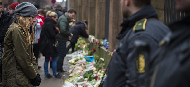 Well wishers from the Jewish community react as they bring flowers and light candles to honour the shooting victims outside the main Synagogue in Copenhagen, Denmark on February 15, 2015. Two fatal attacks in the Danish capital, at a cultural center during a debate on Islam and free speech and a second outside the city's main synagogue. France's ambassador to Denmark Francois Zimeray, who was attending the debate, told AFP the attackers were seeking to replicate the January 7 assault by jihadists in Paris on satirical newspaper Charlie Hebdo that left 12 dead. AFP PHOTO / ODD ANDERSEN (Photo credit should read ODD ANDERSEN/AFP/Getty Images)