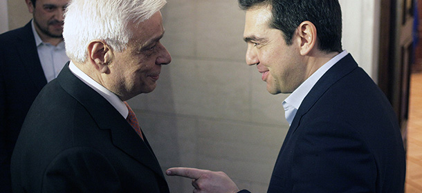 Greece's Prime Minister Alexis Tsipras, right, welcomes conservative former interior minister Prokopis Pavlopoulos at Maximos Mansion in Athens, Tuesday, Feb. 17, 2015. Pavlopoulos, 64, on whose watch authorities failed to contain Greece's worst riots in decades, was named Tuesday as the government-backed candidate for the ceremonial position of Greek president. Pavlopoulos, law professor, must be approved by Parliament, in a special process that can take up to three votes. (AP Photo/Eurokinissi, Giorgos Kontarinis) GREECE OUT