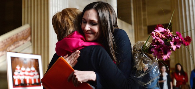 Lee Carter, left, hugs Grace Pastine, litigation director of the British Columbia Civil Liberties Association, inside The Supreme Court of Canada, Friday morning, Feb. 6, 2015, in Ottawa, Ontario. Canada's highest court Friday, unanimously struck down a ban on doctor-assisted suicide for mentally competent patients with terminal illnesses. Carter and her husband accompanied her 89-year-old mother Kathleen (Kay) Carter, who suffered from spinal stenosis, to Switzerland in 2010 where assisted suicide is legal, to end her life. (AP Photo/The Canadian Press, Sean Kilpatrick)