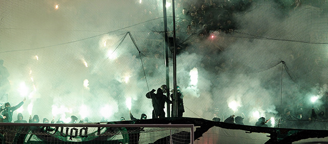 Panathinaikos' fans hold flares during a Greek Super League soccer match against Olympiakos at the Apostolos Nikolaides stadium in Athens, Sunday, Feb.22, 2015. (AP Photo/Yorgos Karahalis)