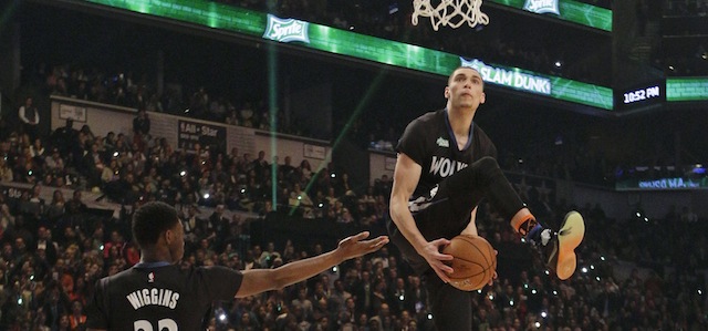Minnesota Timberwolves' Zach LaVine, right, takes the ball from teammate Andrew Wiggins as he competes during the NBA All-Star Saturday Slam Dunk basketball contest Saturday, Feb. 14, 2015, in New York. (AP Photo/Frank Franklin II)