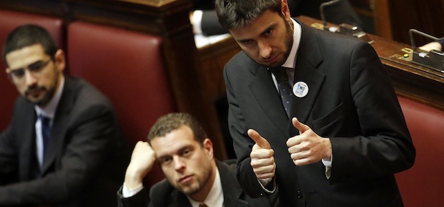 Five Stars Movement party lawmaker Alessandro Di Battista shows the thumbs up sign as he attends a parliament session to elect the lower chamber president in Rome, Saturday, March 16, 2013. Italy's newly elected Parliament was locked in political gridlock as it convened Friday for the first time after elections gave no party a clear victory. The normally routine inaugural duty of electing leaders of both houses was caught in a stalemate, auguring badly for the establishment of the stable government needed to keep the eurozone's third-largest economy on a straight fiscal path while introducing growth measures to bring Italy out of recession and get more Italians back to work. (AP Photo/Gregorio Borgia)