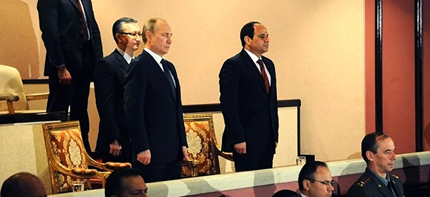 In this image released by the Egyptian Presidency, Egyptian President Abdel-Fattah el-Sissi, right, stands with Russian President Vladimir Putin at the Cairo Opera House in Egypt, Monday, Feb. 9, 2015. Putin arrived in Cairo on Monday to meet his Egyptian counterpart, with both sides eager to strengthen ties and show both have options outside of the West to pursue their goals. The visit, the first by Putin to Egypt in a decade, is largely symbolic, analysts say. (AP Photo/Egyptian Presidency)