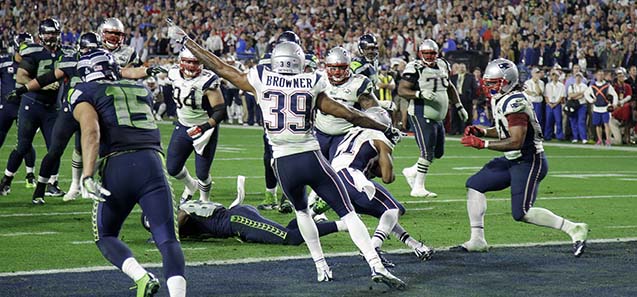 New England Patriots' Brandon Browner (39) celebrates as strong safety Malcolm Butler (21) intercepts a pass from Seattle Seahawks quarterback Russell Wilson during the second half of NFL Super Bowl XLIX football game Sunday, Feb. 1, 2015, in Glendale, Ariz. (AP Photo/Matt Rourke)