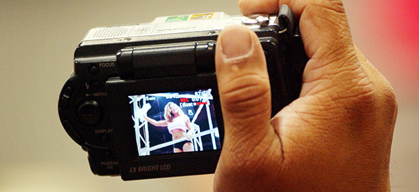 SAN DIEGO, CA - JUNE 7: (FEATURE ON THE EROTICA LA 2002 TRADESHOW, 7 OF 14) A man aims his digital camera at an exotic dancer at the Erotica LA 2002 adult industry tradeshow on June 7, 2002 in Los Angeles, California. Attendees are encouraged to bring their cameras. Erotica LA draws more than 20,000 attendees to its annual three-day event which is open to the public. (Photo by David McNew/Getty Images)