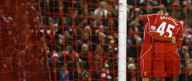 Liverpool's Mario Balotelli, center, celebrates scoring against Tottenham with teammates during the English Premier League soccer match between Liverpool and Tottenham Hotspur at Anfield Stadium, Liverpool, England, Tuesday Feb. 10, 2015. (AP Photo/Jon Super)