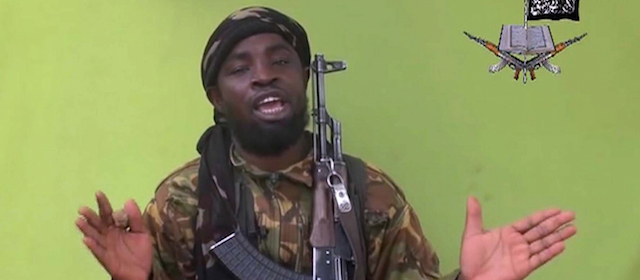 FILE - This is a Monday May 12, 2014 file photo taken from video by Nigeria's Boko Haram terrorist network, and shows their leader Abubakar Shekau speaking to the camera. Suspected Boko Haram militants attacked a village on the shore of Lake Chad early Friday Feb. 13, 2015 marking the first such violence against the neighbor contributing the most military might to the regional fight against the Nigeria-based terror group. (AP Photo/File)