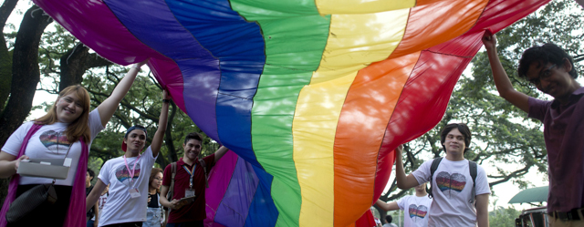 Supporters of lesbian, gay, bisexual, and transgender (LGBT) groups wave a huge rainbow banner as they march at the University of the Philippines (UP) campus in Manila on September 26, 2014. The march called for the need for policies that will combat discrimination against students based on sexual orientation and gender identity and expression. AFP PHOTO / NOEL CELIS (Photo credit should read NOEL CELIS/AFP/Getty Images)