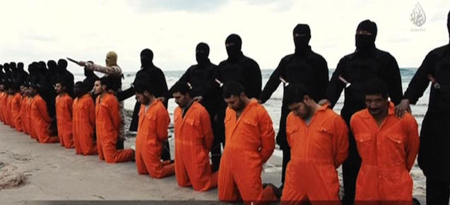 Men in orange jumpsuits purported to be Egyptian Christians held captive by the Islamic State (IS) kneel in front of armed men along a beach said to be near Tripoli, in this still image from an undated video made available on social media on February 15, 2015. Islamic State released the video on Sunday purporting to show the beheading of 21 Egyptian Christians kidnapped in Libya. In the video, militants in black marched the captives to a beach that the group said was near Tripoli. They were forced down onto their knees, then beheaded. Egypt's state news agency MENA quoted the spokesman for the Coptic Church as confirming that 21 Egyptian Christians believed to be held by Islamic State were dead. REUTERS/Social media via Reuters TV (CIVIL UNREST CONFLICT TPX IMAGES OF THE DAY) ATTENTION EDITORS - THIS PICTURE WAS PROVIDED BY A THIRD PARTY VIDEO. REUTERS IS UNABLE TO INDEPENDENTLY VERIFY THE AUTHENTICITY, CONTENT, LOCATION OR DATE OF THIS IMAGE. THIS PICTURE IS DISTRIBUTED EXACTLY AS RECEIVED BY REUTERS, AS A SERVICE TO CLIENTS. FOR EDITORIAL USE ONLY. NOT FOR SALE FOR MARKETING OR ADVERTISING CAMPAIGNS. NO SALES. NO ARCHIVES