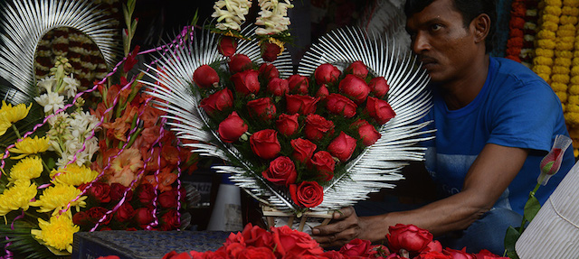 An Indian flower seller arranges varieties of roses at a roadside stall ahead of Valentine's Day in Siliguri on February 13, 2015. Despite opposition from some right-wing groups who see the day as counter to traditional Indian culture, Valentine's Day is celebrated in India as Rashtriya Prem Divas. AFP PHOTO / Diptendu DUTTA (Photo credit should read DIPTENDU DUTTA/AFP/Getty Images)