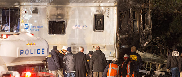 VALHALLA, NY - FEBRUARY 3: Metropolitan Transportation Authority (MTA) workers and police investigate a Metro-North train crash on February 3, 2015 in Valhalla, New York. A Metro-North commutor train carrying hundreds of passengers struck a vehicle at a railroad crossing killing at least seven people and injuring many more. (Photo by Michael Graae/Getty Images)