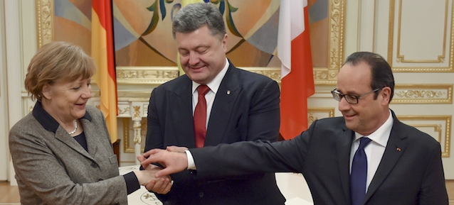 Ukrainian President Petro Poroshenko, center, French President Francois Hollande, right, and German Chancellor Angela Merkel shake hands during their meeting in Kiev, Ukraine, Thursday, Feb. 5, 2015. The leaders of France and Germany were carrying a new peace initiative to the Ukrainian and Russian capitals Thursday, amid a flurry of high-level diplomacy to end what Hollande called a war on Europe's edge. (AP Photo/Presidential Press Service, Mykola Lazarenko)