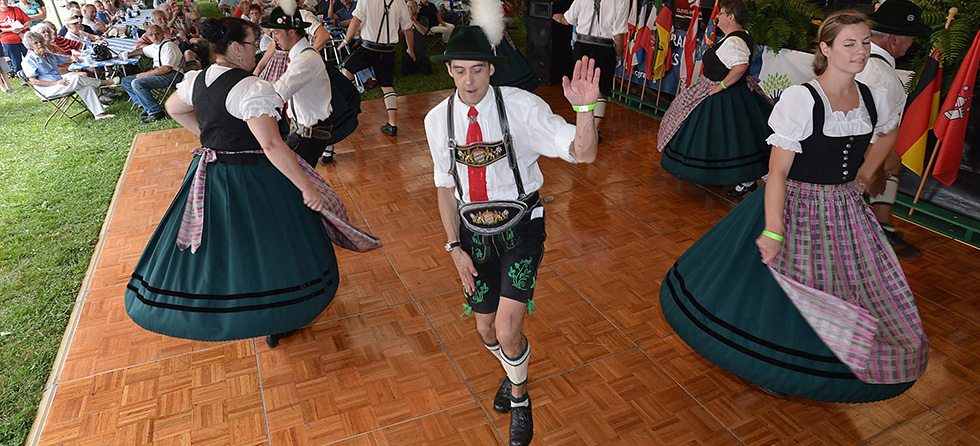 The Alpen Schuhplattler Dancers, a German folk dance group from Pittsburgh, entertain the crowd during the 18th annual German Heritage Fest held Saturday, Aug. 30, 2014, at St. Nick's Grove in Millcreek Township, Pa. In the foreground from left are: Kim Wright, 50; Eric Christian, 46; and Anna Giuliano, 29. (AP Photo/Erie Times-News, Christopher Millette)