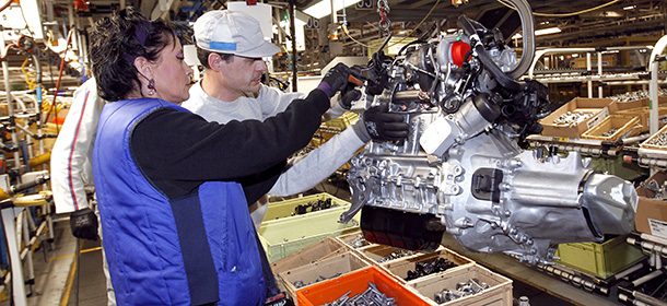 Employees work on a motor assembly line at the French automaker PSA Peugeot-Citroen plant in Poissy, near Paris, on January 27, 2012.AFP PHOTO THOMAS SAMSON (Photo credit should read THOMAS SAMSON/AFP/GettyImages)