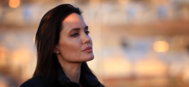 US actress and UNHCR ambassador Angelina Jolie stands during a visit to a camp for displaced Iraqis in Khanke, a few kilometres (miles) from the Turkish border in Iraq's Dohuk province, on January 25, 2015. Run by authorities from the three-province autonomous Kurdish region of north Iraq with the help of the United Nations refugee agency, the UNHCR, Khanke aims to house 18,000 people, said the agency's Liena Veide. AFP PHOTO/SAFIN HAMED (Photo credit should read SAFIN HAMED/AFP/Getty Images)