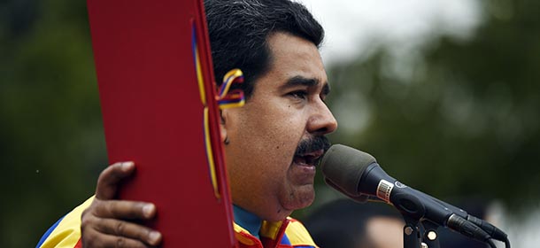 Venezuelan President Nicolas Maduro speaks whilst holding the folder with the decree powers law, in Caracas on March 15, 2015. Venezuela's National Assembly voted Sunday to give President Nicholas Maduro decree-making powers in defense and security affairs amid an escalating confrontation with Washington. The special powers were approved by a show of hands in the assembly after two hours of debate and will be in effect for six months. AFP PHOTO/JUAN BARRETO (Photo credit should read JUAN BARRETO/AFP/Getty Images)
