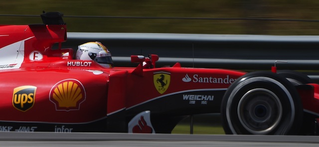 Ferrari's German driver Sebastian Vettel takes a corner during the Formula One Malaysian Grand Prix in Sepang on March 29, 2015. AFP PHOTO / Greg BAKER (Photo credit should read GREG BAKER/AFP/Getty Images)