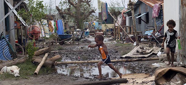 In this March 15, 2015 photo provided by UNICEF Pacific, young children move around debris as residents work to recover from Cyclone Pam in Mele village, on the outskirts of the capital Port Vila, Vanuatu. Vanuatu's President Baldwin Lonsdale said the cyclone that hammered the tiny South Pacific archipelago was a "monster" that has destroyed or damaged 90 percent of the buildings in the capital and has forced the nation to start anew. (AP Photo/UNICEF Pacific) EDITORIAL USE ONLY, NO SALES