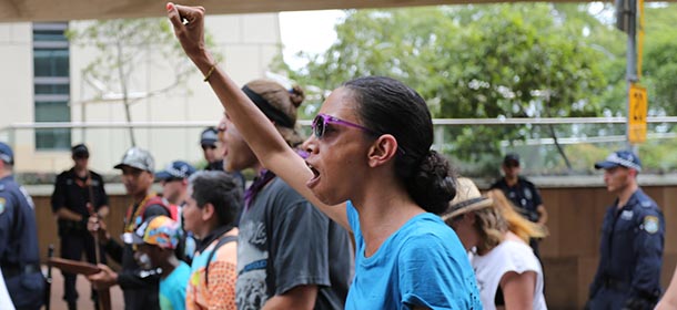 Protesters march through a street, in a rally for Aboriginal rights, in coincidence with the G-20 summit, in Brisbane, Australia, Sunday, Nov. 16, 2014.(AP Photo/Dean Saffron)