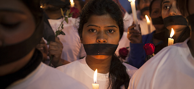 Indian women participate in a candle light vigil at a bus stop where the victim of a deadly gang rape in a moving bus had boarded the bus two years ago, in New Delhi, India, Tuesday, Dec. 16, 2014. The case sparked public outrage and helped make women’s safety a common topic of conversation in a country where rape is often viewed as a woman’s personal shame to bear. (AP Photo/Tsering Topgyal)