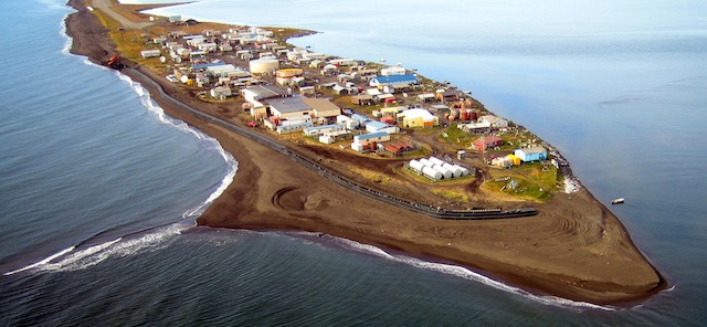 FILE - This Sept. 11, 2006, aerial file photo released by the Northwest Arctic Borough shows the village of Kivalina, Alaska. Two Native villages on Alaska's western coast are coping with shortages of treated water brought on by failures of their supply transmission pipelines. Unalakleet, a largely Inupiat Eskimo community, lost use of its main pipeline when it froze a month ago and developed leaks. Almost 300 miles to the north, Kivalina has imposed strict conservation measures all winter after its pipeline was damaged by late summer storms before the Inupiat community's water tanks could be filled completely.(AP Photo/Northwest Arctic Borough via The Anchorage Daily News)